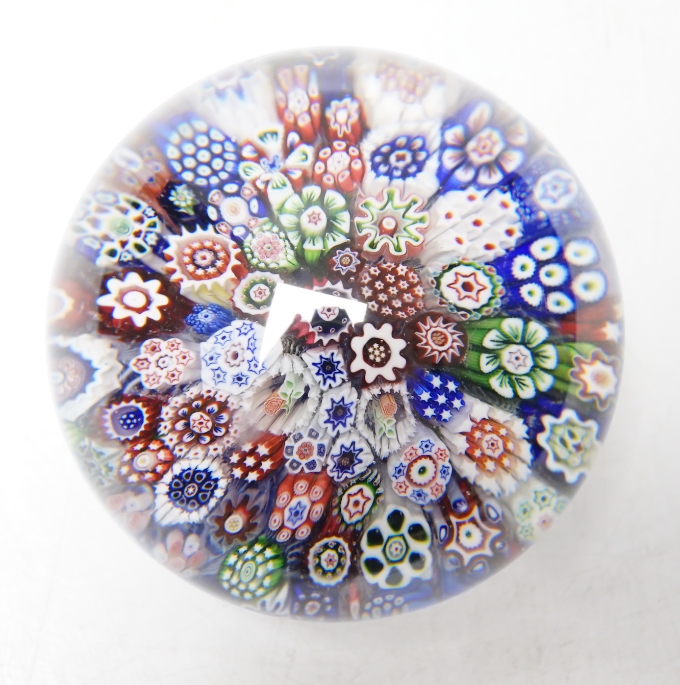 A Baccarat close packed millefiori paperweight with two rose corner, 7cm diameter